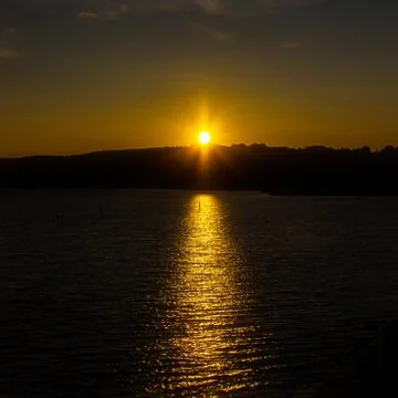 Glittering path on the water surface. Sunset over Lake Taupo Stock Photos