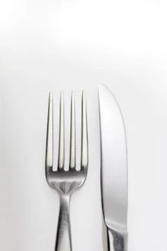 Glittering reflection on a fork and knife Stock Photos