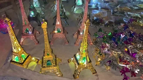 Glittering souvenirs and key chains of the Eiffel Tower. Stock Footage 234811643