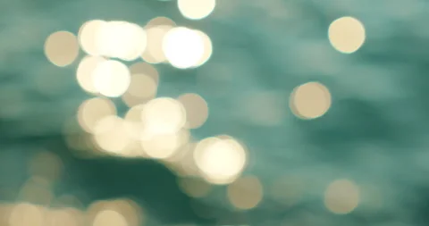 Glittering sun reflections create abstract bokeh pattern on ocean ripples Stock Footage 326005911