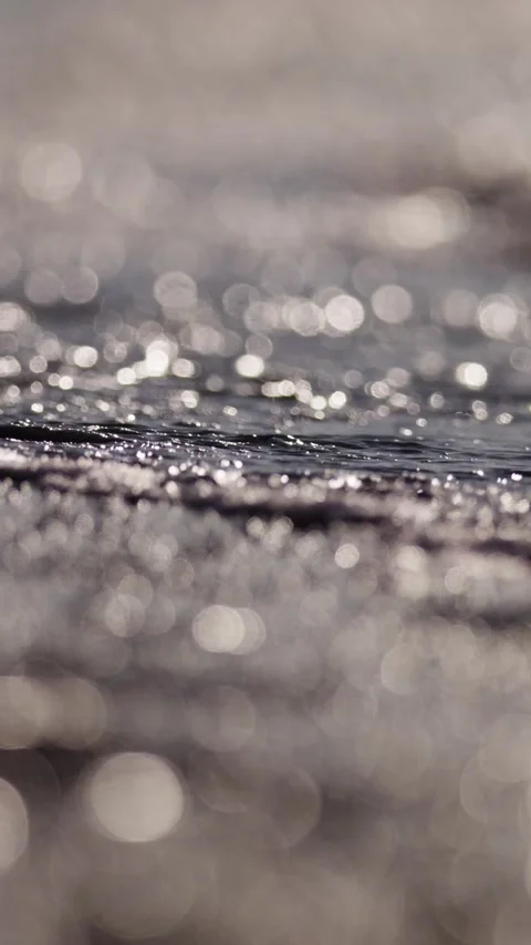 Glittering Water Surface with Soft Bokeh in Natural Light Stock Footage 335197671