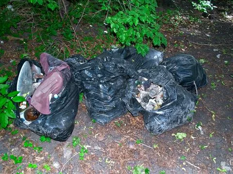 Global eco problem, Pollution of the planet. Dirty bags with garbage and plas Stock Photos