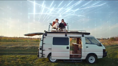 Global lines connection through tablet on the camper van roof, couple planning Stock Footage 248917814