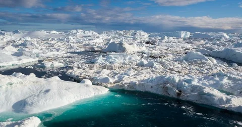 Global Warming and Climate Change - Icebergs from melting glacier in icefjord Video stock 88025050