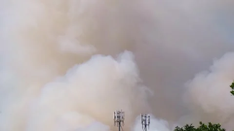 Global warming and dry air cause large white and gray smoke plumes to rise .. Stock Footage 300080252
