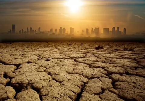 Global Warming and pollution theme with cracked land and the cityscape Stock Photos