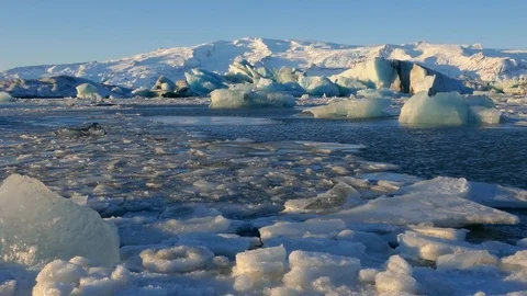 Global warming climate change iceberg floe broken from glacier melting in water Stock Footage