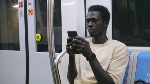 Globalization, social - black man on the subway types on his smartphone Stock Footage 240325838
