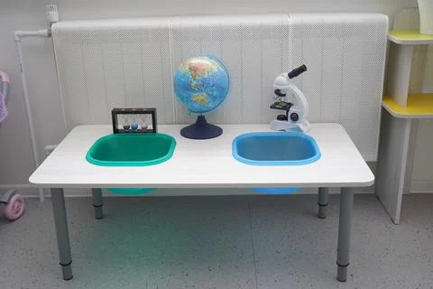 Globe and microscope on the children's table Stock Photos