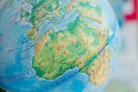Globe on the background of the map of the world. Close-up Stock Photos