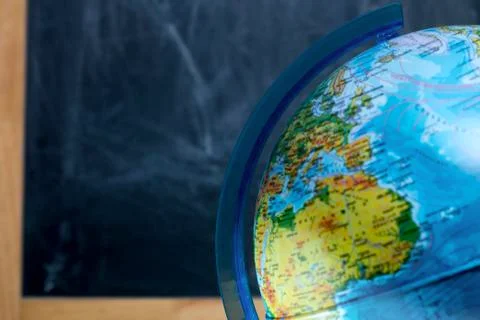 Globe on the background of the school board for drawing with chalk Stock Photos