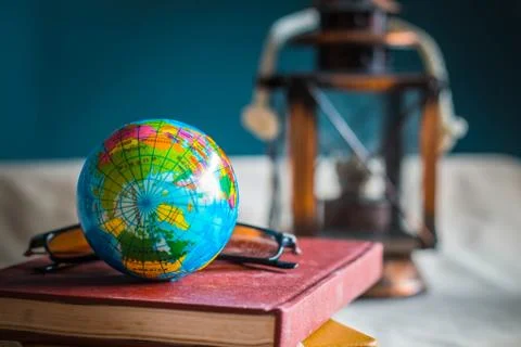 Globe on a books at work.. Stock Photos