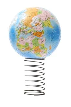 Globe bouncing on metal spring Stock Photos