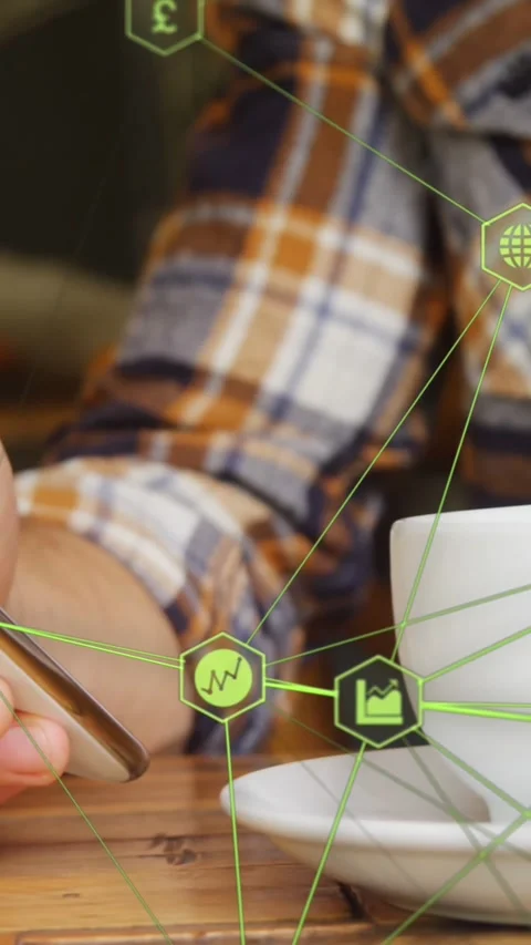 Globe of digital icons against mid section of man using smartphone and drinking Stock Footage 324785743