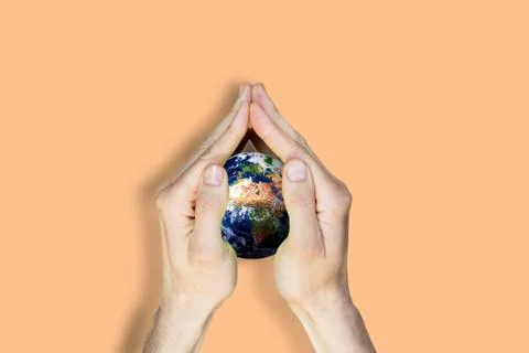 Globe in the hands. Elements of this image furnished by NASA Stock Photos