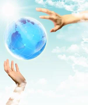 Globe in human hand against blue sky. Stock Photos