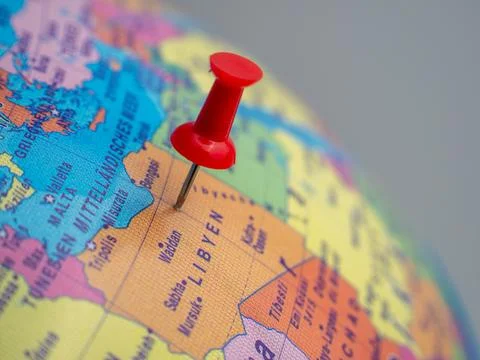 The globe indicates the country of Libya with a push pin. Stock Photos