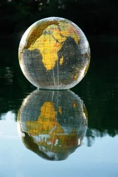 Globe on lake Stock Photos