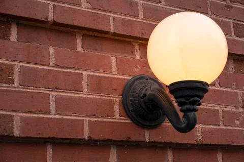 Globe light on brick wall illuminated glow Foto stock