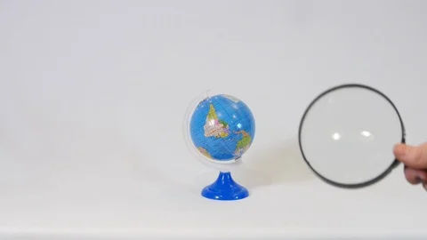 Globe with Magnifying Glass Stock Footage 100691174