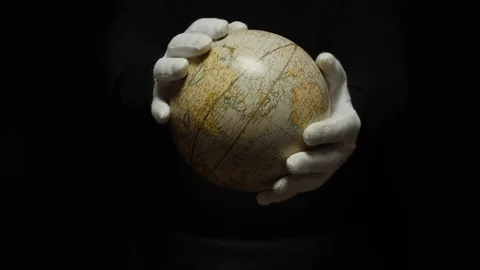 Globe on man hands isolated on black background Stock Footage 128623522