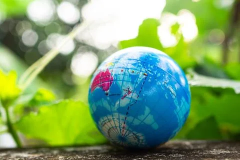 Globe model on green leaf nature background, earth world in forest growth Stock Photos
