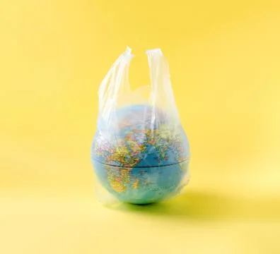 Globe model in plastic bag, save the world environment Stock Photos