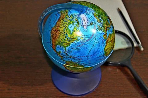 Globe notebook pencil and globe on the table Stock Photos