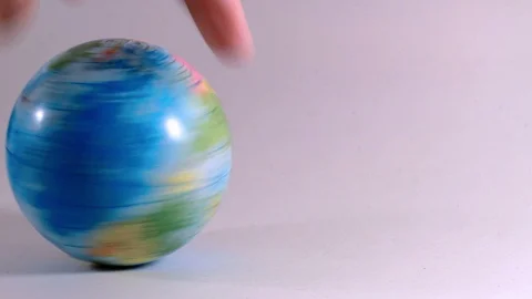 Globe is rotated hard by a hand of a man, symbolizes ecological problems Stock Footage 97877783