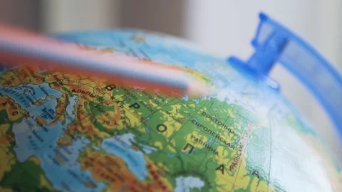Globe with russian names of cities and countries, leading pencil on the map Stock Footage 89128595