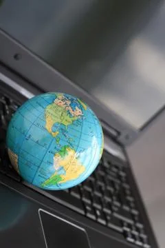 Globe setting on a laptop Stock Photos
