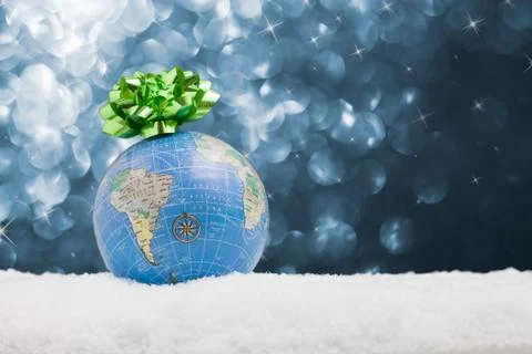 Globe in the snow with starry background Stock Photos
