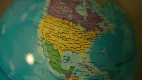 Globe spins gently, showing continents with clear labels. Yellow United States Stock Footage 342351148