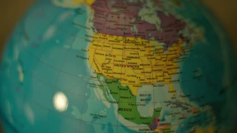 Globe spins slowly in warm, focused light. North and South America dominate the Stock Footage 341829445