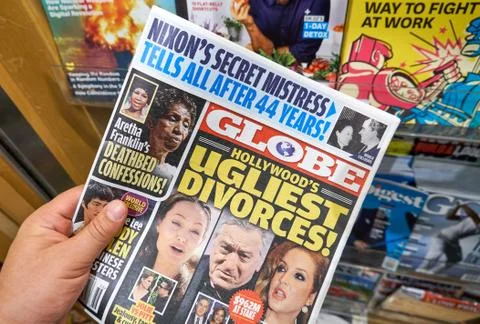 Globe tabloid in a hand Stock Photos