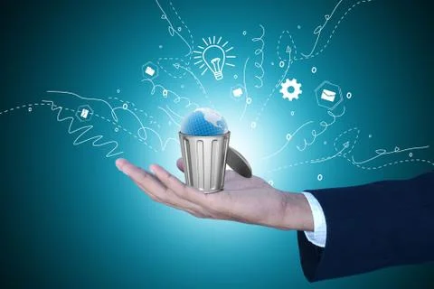 Globe in trash bin showing the smart hand Stock Photos