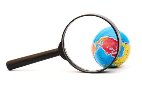 Globe under a magnifier Stock Photos