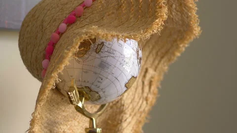 Globe wearing hat on the table in 4K slow motion 60fps Stock Footage 126696920