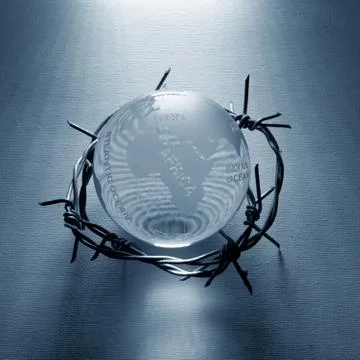Globe wrapped in barb wire Stock Photos