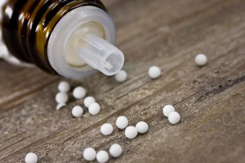 Globuli on wooden table Stock Photos