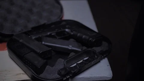 Glock gun lies in a case on a table Stock-Footage 126371032