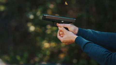 Glock shooting practice. Slow motion video of firing the gun the right way Stock Footage 231693833