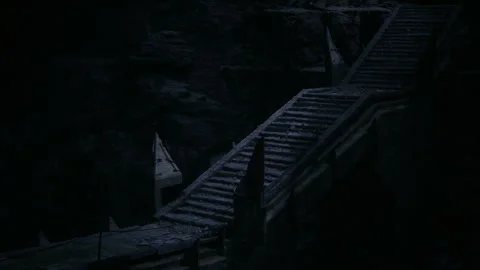 Gloomy bridge scene. Desolate bridge spanning chasm bathed in feeble glow Stock Footage 343621250