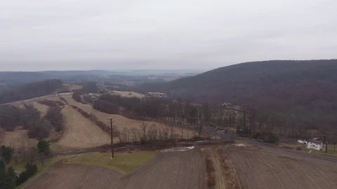 Gloomy farm fields in the hills Stock Footage 71697809