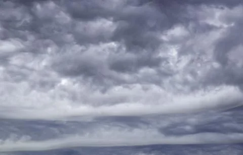 Gloomy gray low clouds, dramatic sky background Stock Photos