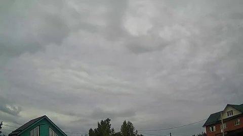 Gloomy overcast sky with clouds moving over rooftops Stock Footage 341294323