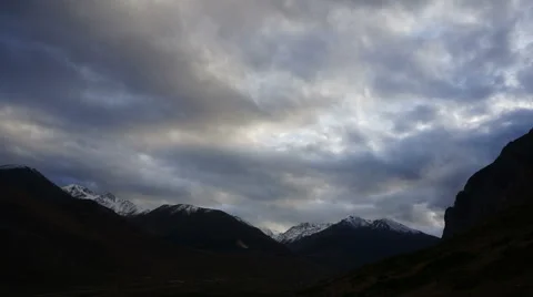 Gloomy skies, snow capped peaks, deep shade. Timelapse Stock Footage 59063652