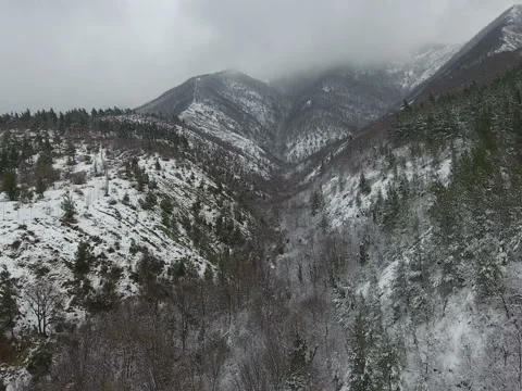 Gloomy snow-covered mountain range, aerial view Stock Footage 72711362
