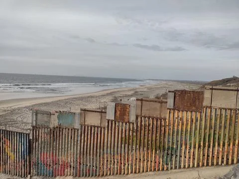 Gloomy View of Rusty Protective Border Wall Mexico Tijuana and United States Stock Photos