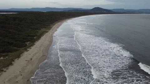 Gloomy/cloudy day at the beach with strong waves - Drone/Aerial shot Stock Footage 144224665